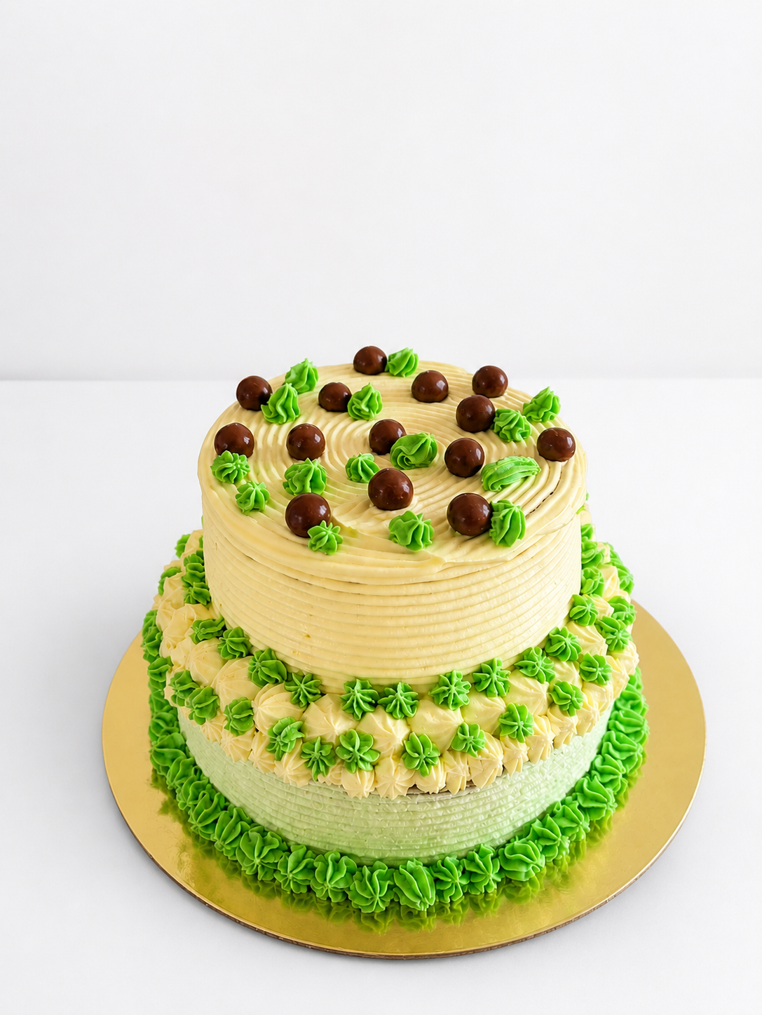 Two-tier green and cream cake